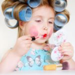 child puts on makeup