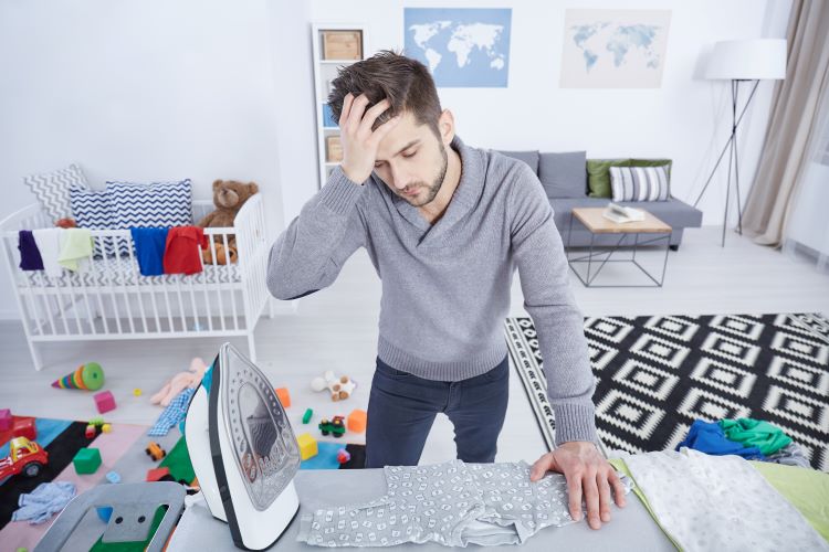 tired dad ironing