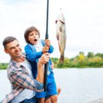 dad teaches son to fish