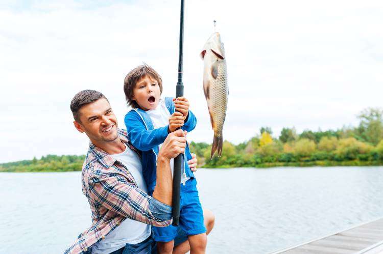 dad teaches son to fish