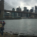 My father carries my son by the Brooklyn Bridge