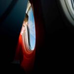 boy looking out plane window