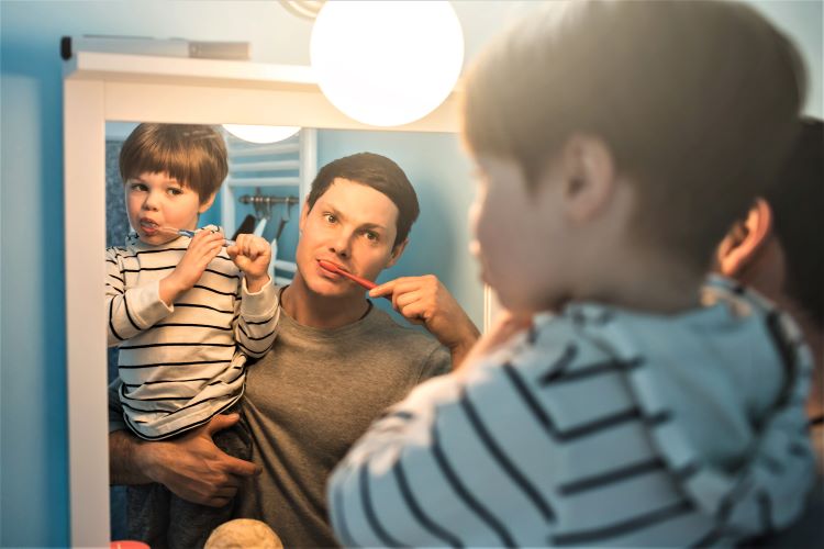 awkward reflections father son brush teeth mirror