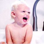 baby in tub taking a bath