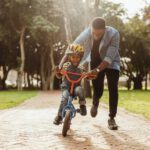 being present father teaches child ride bike 1