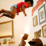 beleaf melanin tosses his child in the air