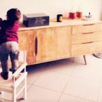 child-proof toddler on chair reaching for item