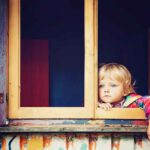 child looking out window