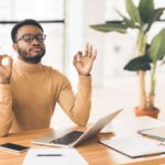 coping strategies man meditating at his desk