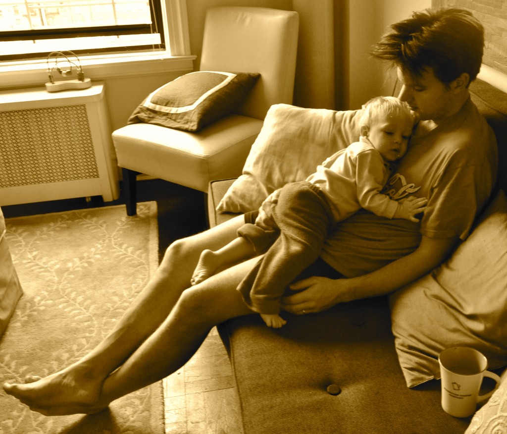 dad holding child on couch