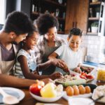 family habits Black parents kids cooking together 1