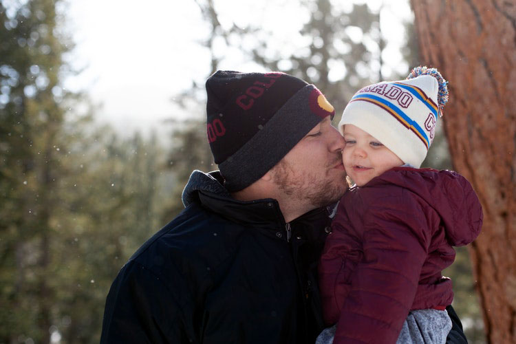 father kisses child parenting bias against fathers