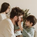 favorite parent boy touches dad face happy