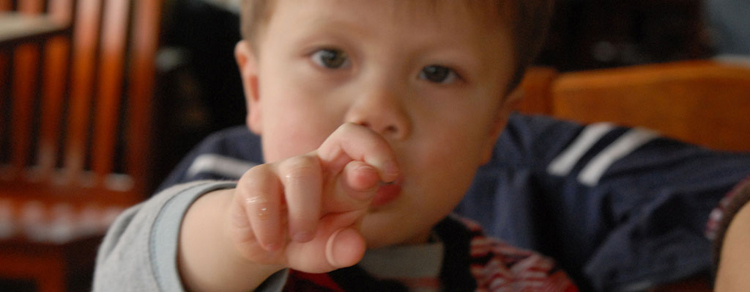 luck child with fingers crossed-luck