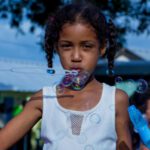 unscheduled summer girl blowing bubbles