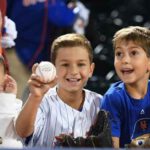 mets family fun kids with baseballs at citi field
