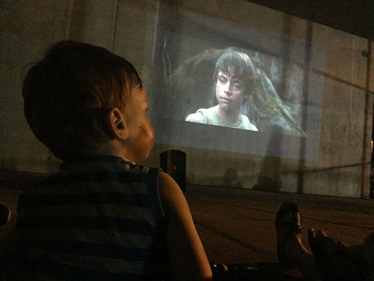 boy watches star wars on screen