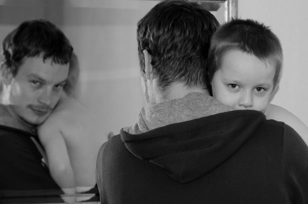 stay-at-home dads look in mirror