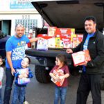Vegas Dads Group organizer Kevin "Spike" Zelenka, left; group member and their children unload a donation of Huggies diapers to the Las Vegas Diaper Bank.