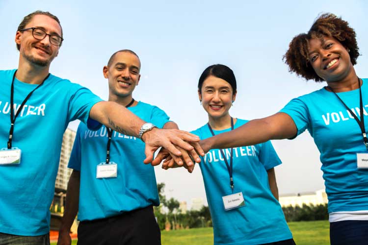 volunteer hands in together